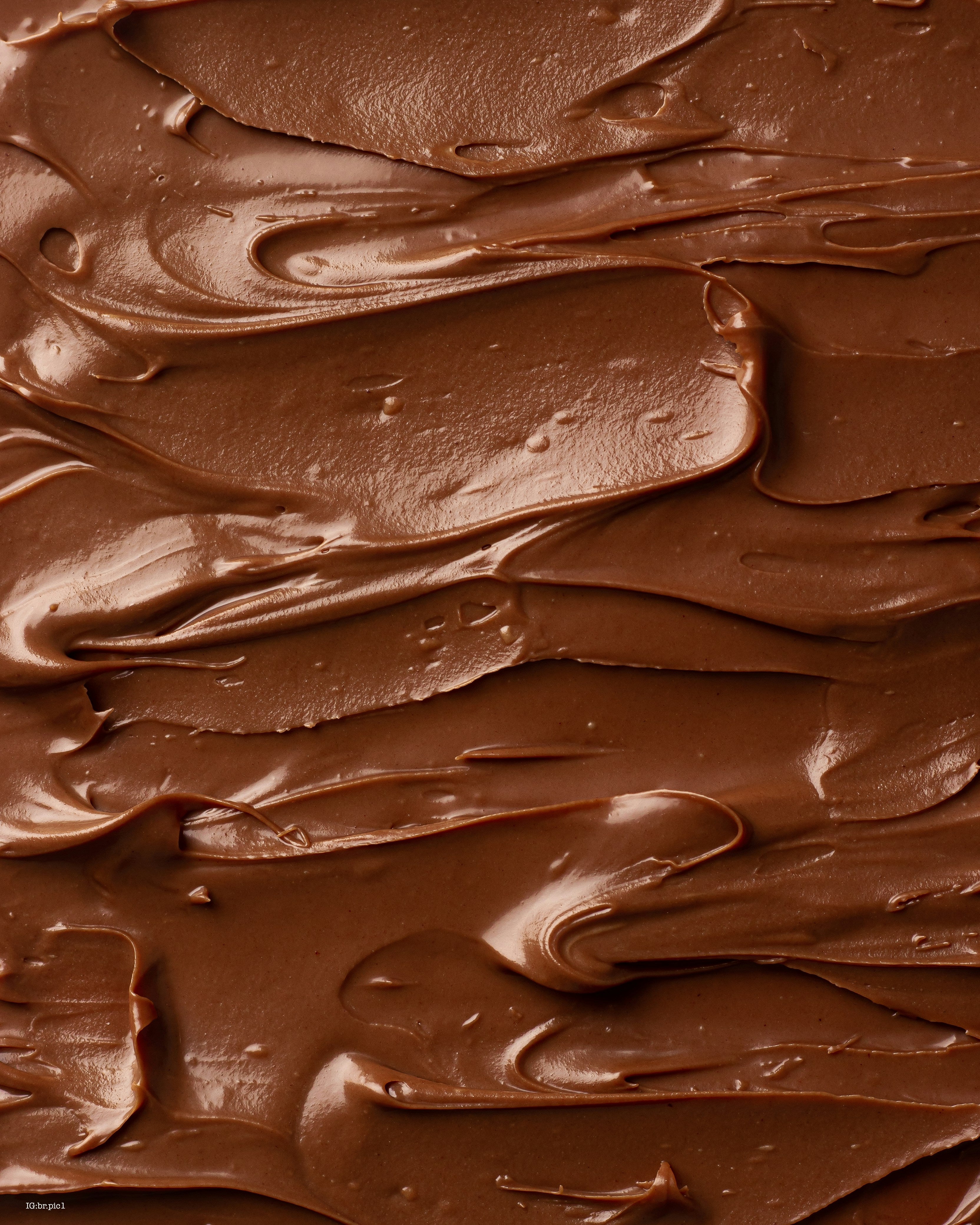 Close-up of smooth chocolate frosting texture. Photo by <a href="https://unsplash.com/@br_pic1?utm_source=unsplash&utm_medium=referral&utm_content=creditCopyText">bader photographer</a> on <a href="https://unsplash.com/photos/a-close-up-of-a-cake-with-chocolate-frosting-OLwCpJmzJOA?utm_source=unsplash&utm_medium=referral&utm_content=creditCopyText">Unsplash</a>